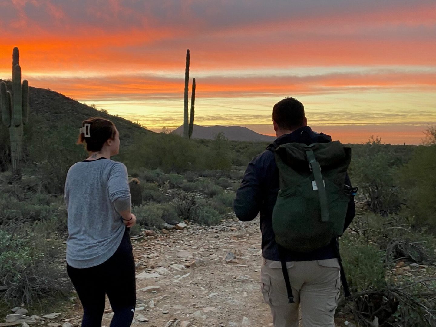 a couple of people standing on top of a hill